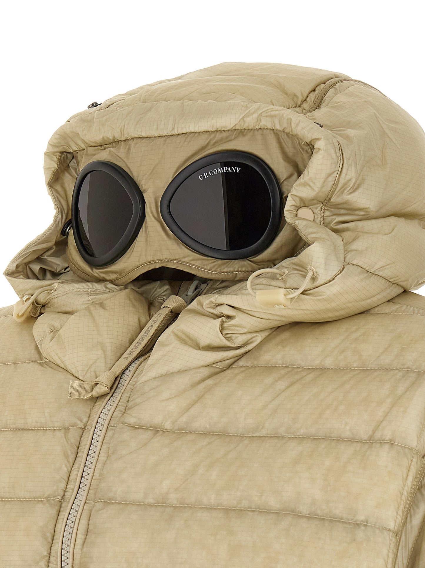 Hooded Puffer Jacket by C.P. Company for men in polyamide beige & sand presents a effortlessly chic silhouette, showcasing a sophisticated and premium pockets, hooded & insulated for a truly effortlessly chic finish.