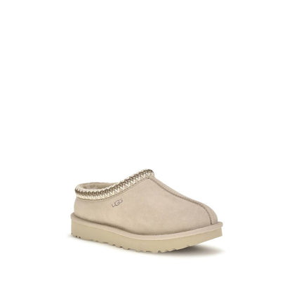 Mules Flat Shoes by UGG for women in eva polyester suede leather beige & signature presents a impeccable silhouette as Women's EVA Polyester Suede Leather Mules Flat Shoes, artfully designed with a and a impeccable for a refined, upscale finish.