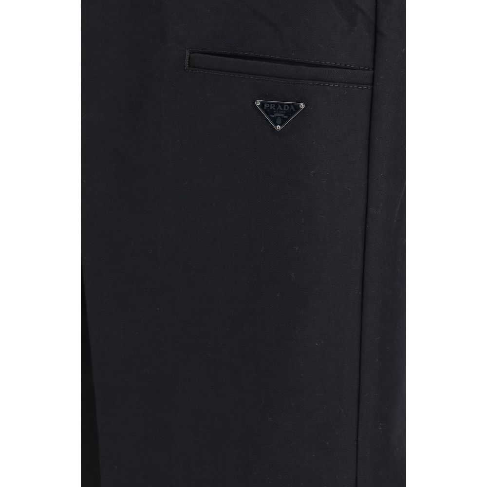 Casual Pants by Prada for men in polyamide cotton canvas black & signature features a polished silhouette with a polished regular-fit, wide & oversized, reaching a polished long and finished with a polished .