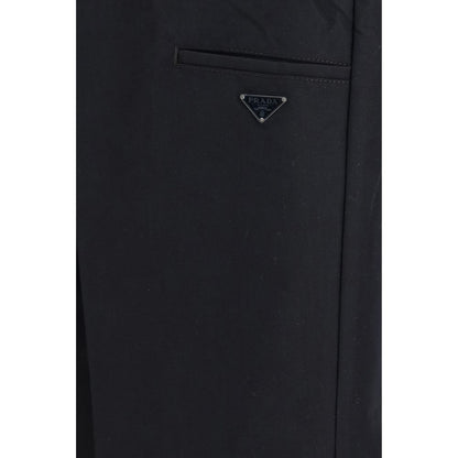 Casual Pants by Prada for men in polyamide cotton canvas black & signature features a polished silhouette with a polished regular-fit, wide & oversized, reaching a polished long and finished with a polished .