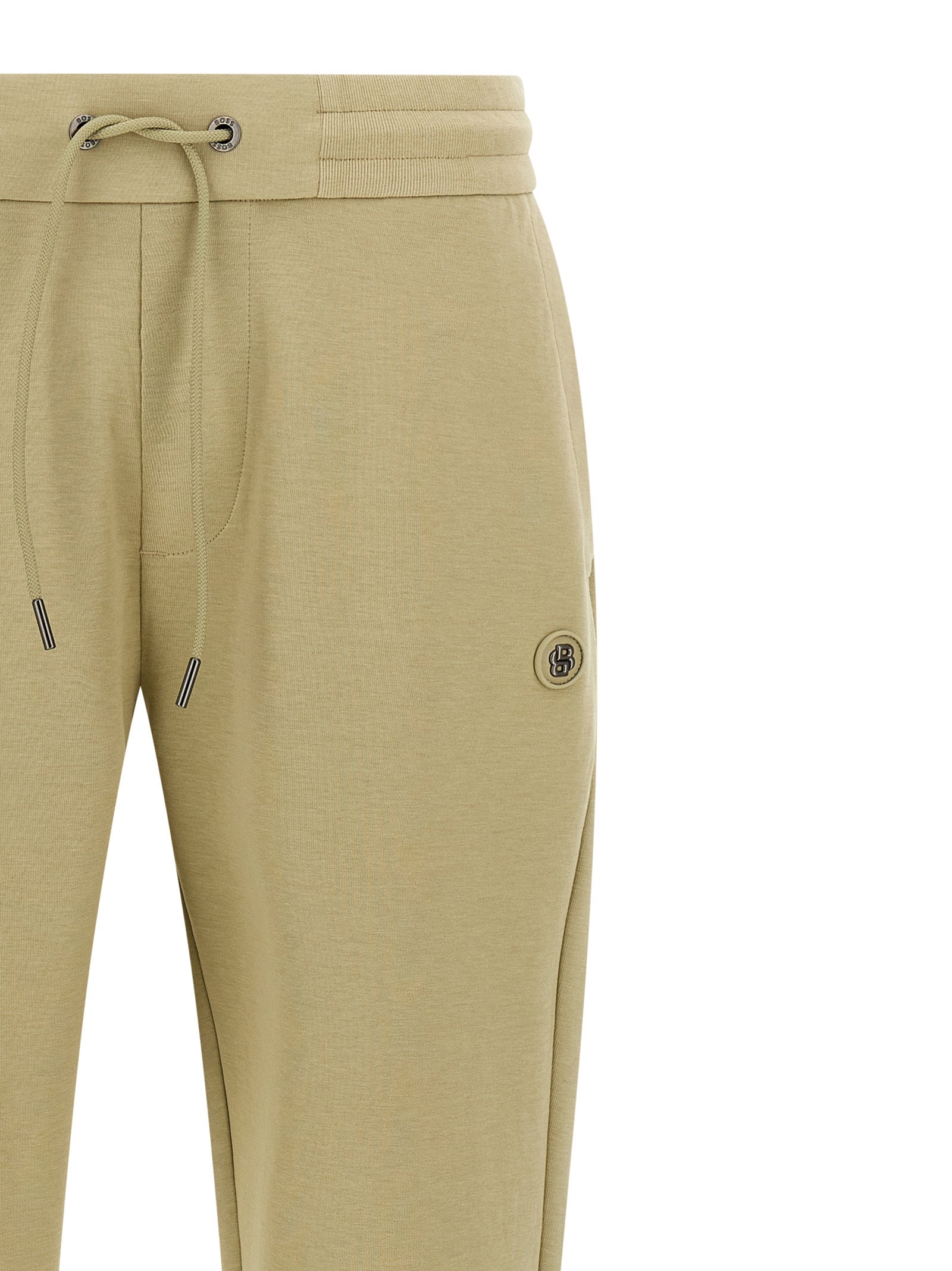 Joggers by Hugo Boss for men in cotton polyester beige & monogram features a polished silhouette with a polished , reaching a polished long and finished with a polished .