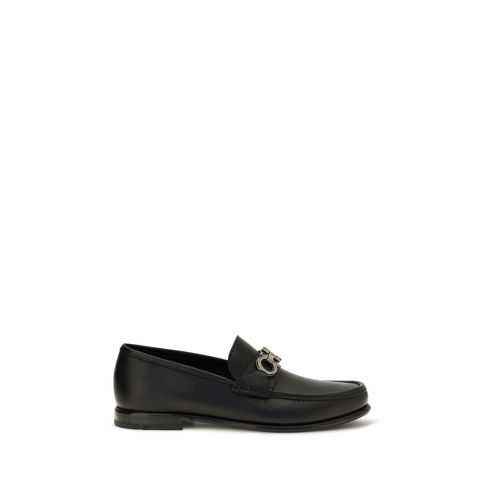 This Loafer Slip-On Shoes by Ferragamo for men in bos taurus calf leather black & signature features an exquisite silhouette from the Gancini Men's Bos Taurus Calf Leather Loafer Slip-On Shoes collection, defined by a sophisticated and elegant .