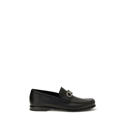 This Loafer Slip-On Shoes by Ferragamo for men in bos taurus calf leather black & signature features an exquisite silhouette from the Gancini Men's Bos Taurus Calf Leather Loafer Slip-On Shoes collection, defined by a sophisticated and elegant .