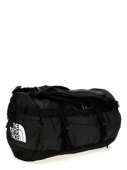 Small Travel Flap Backpack by The North Face for unisex in lyocell polyester mesh black features a fashionable silhouette, showcasing the Base Camp Duffel City Lyocell Polyester Mesh Small Travel Flap Backpack design with a secure flap & zipper, ample , and versatile backpack-strap, adjustable-strap & handle.