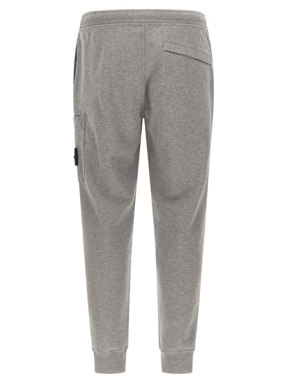 Jogger Sweatpants by Stone Island for men in cotton gray features an dynamic tapered-leg with long, , and functional for an dynamic silhouette.