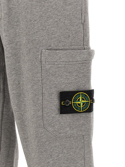 Jogger Sweatpants by Stone Island for men in cotton gray features a versatile silhouette, integrating performance with a versatile tapered-leg, long, and comfortable .
