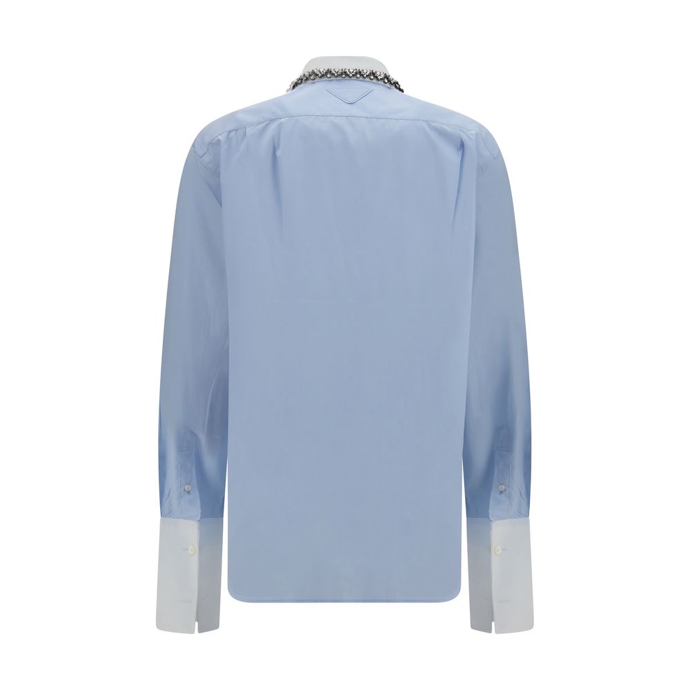 Dress Shirt by Prada for women in cotton blue presents a discerning silhouette, showcasing a sophisticated and for a truly discerning finish.