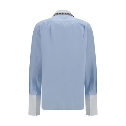 Dress Shirt by Prada for women in cotton blue presents a discerning silhouette, showcasing a sophisticated and for a truly discerning finish.