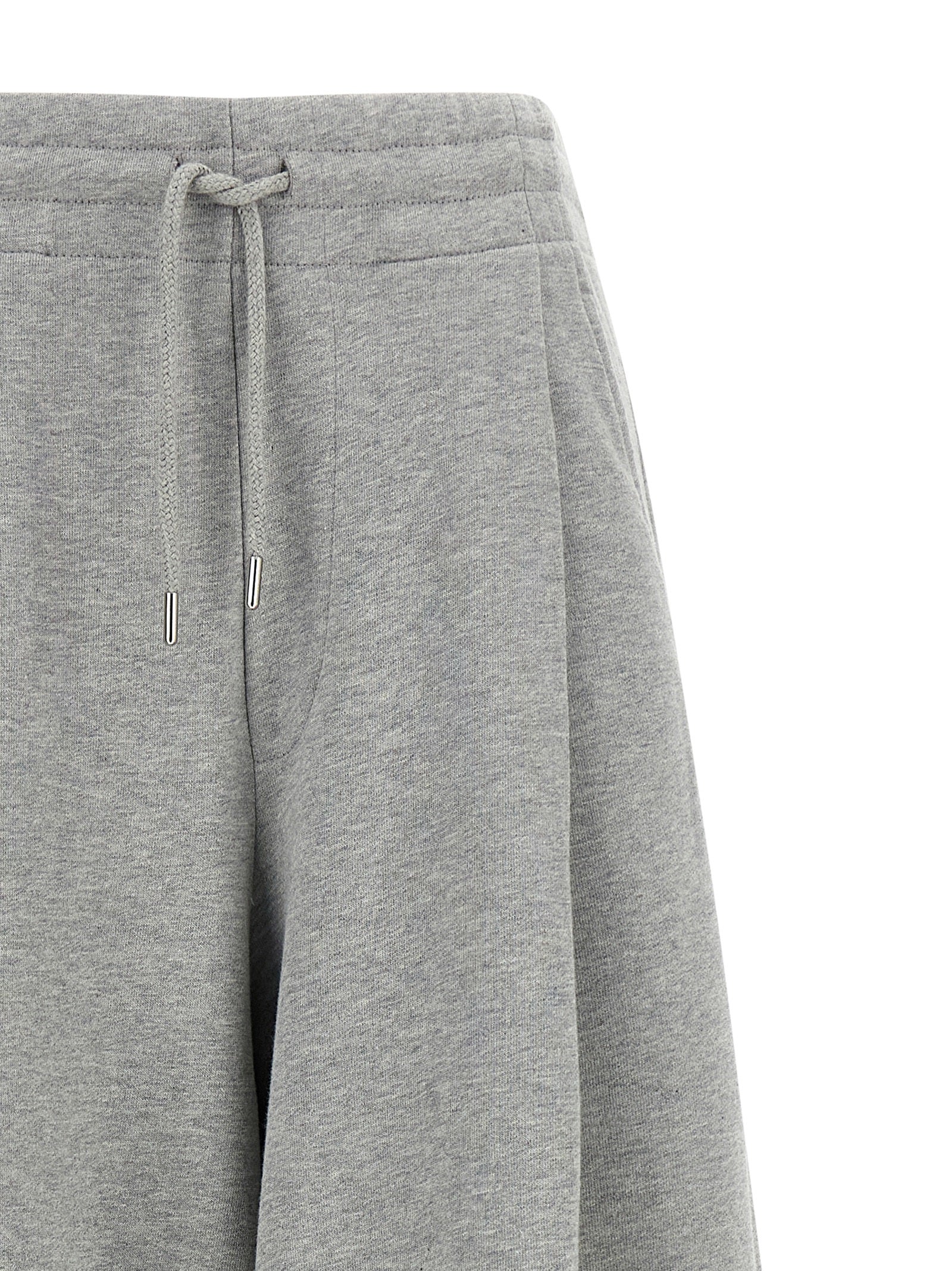 Casual Pants by Dries Van Noten for women in cotton gray & silver presents a tailored silhouette, showcasing a tailored wide and long cut with a refined mid rise for a truly tailored aesthetic.