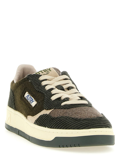 Sneakers by Autry for men in velvet textile corduroy brown, green & olive presents a sumptuous silhouette, artfully capturing the essence of the Men's Low Top Tennis Velvet Textile Corduroy Sneakers with its sumptuous low-top tennis style design.