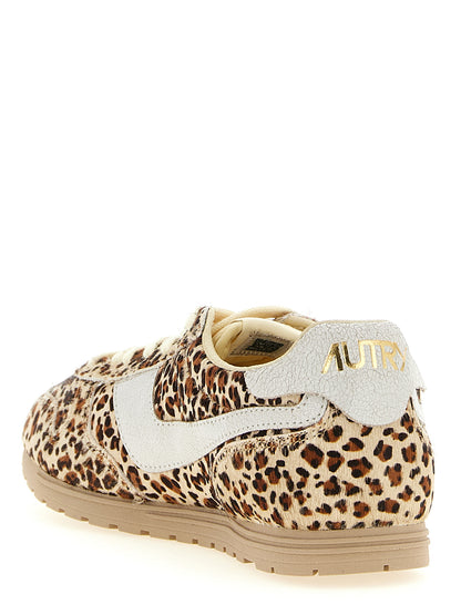 Sneakers by Autry for women in bos taurus cowhide leather gold, multicolor & print presents a impeccable silhouette as Pony Women's Low Top Bos Taurus Cowhide Leather Sneakers, expertly defined by a impeccable low-top style for a impeccable, high-fashion look.