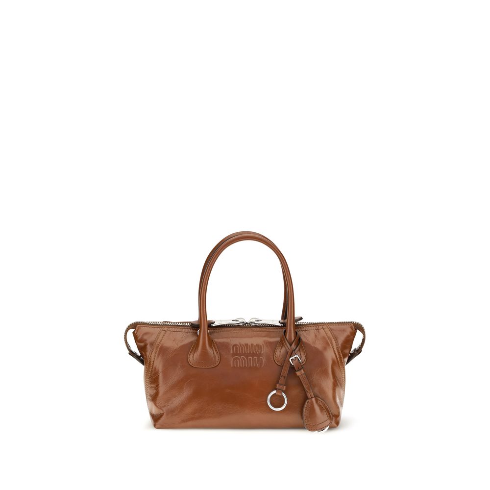 This Mini Flap Handbag by Miu Miu for women in bos taurus calfskin leather and bicolour, brown & green presents a sculptural silhouette featuring a secure snap, flap & zipper, ample , and versatile shoulder-strap, handle, adjustable-strap & detachable-strap for a sculptural finish.