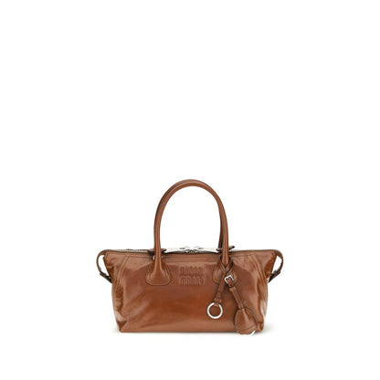 This Mini Flap Handbag by Miu Miu for women in bos taurus calfskin leather and bicolour, brown & green presents a sculptural silhouette featuring a secure snap, flap & zipper, ample , and versatile shoulder-strap, handle, adjustable-strap & detachable-strap for a sculptural finish.