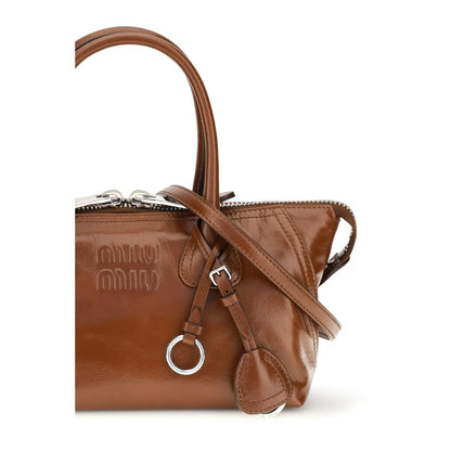 Mini Flap Handbag by Miu Miu for women in bos taurus calfskin leather bicolour, brown & green features a signature silhouette, showcasing a secure snap, flap & zipper and signature with versatile shoulder-strap, handle, adjustable-strap & detachable-strap for a sophisticated look.