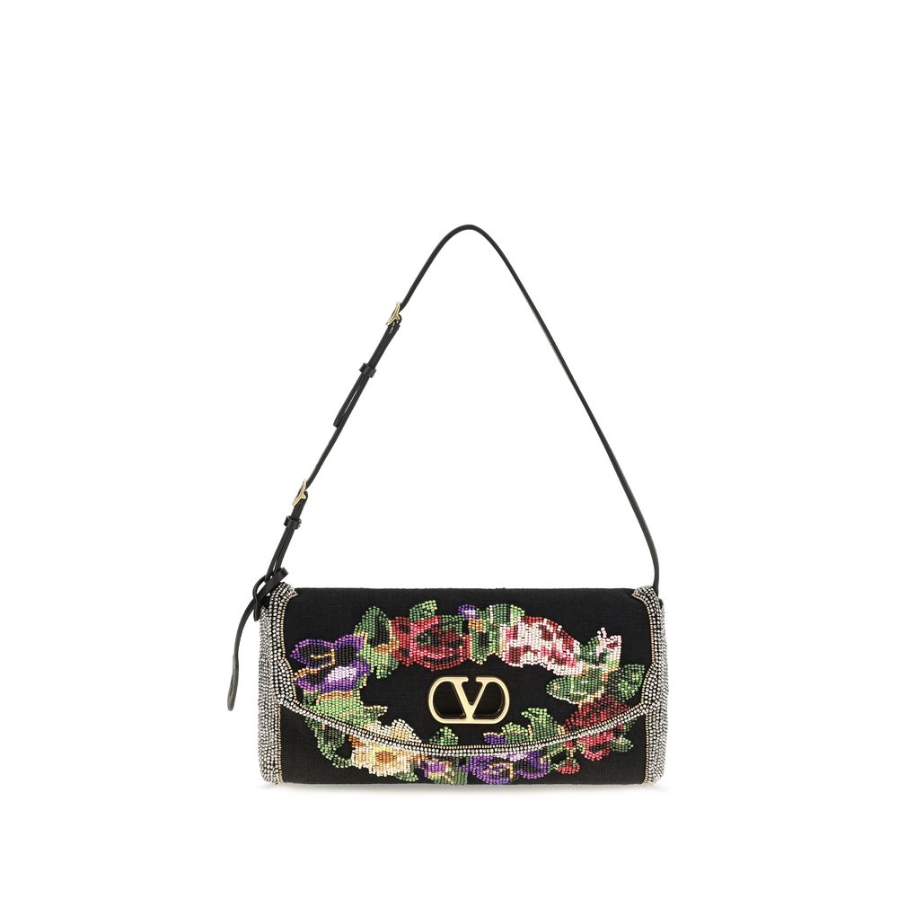 Small Shoulder Bag by Valentino Garavani for women in calfskin leather & linen black, gold, floral & signature features a effortless chic silhouette with a secure magnetic & buckle, ample single-compartment, and versatile shoulder-strap, adjustable-strap & handle for a effortless chic finish.