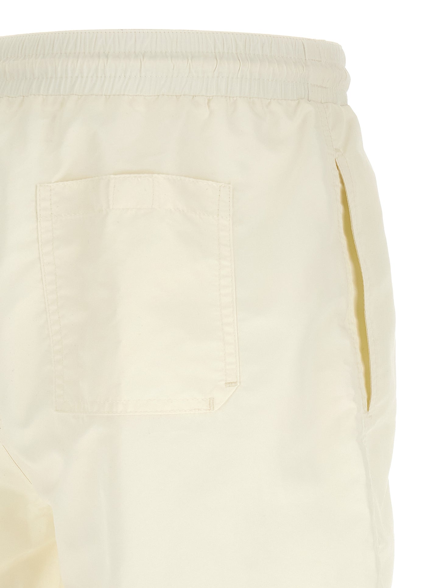 Swim Shorts by Brunello Cucinelli for men in polyester cream & white showcases a contemporary silhouette, artfully capturing the essence of the contemporary Men's Polyester Swim Shorts design for a sophisticated look.