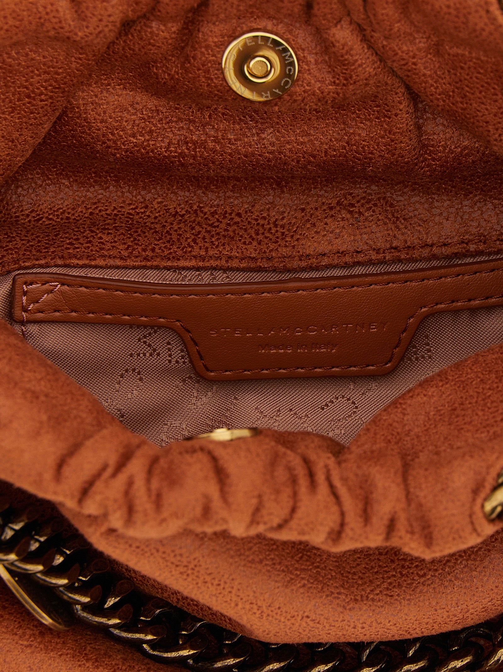 Mini Drawstring Shoulder Bag by Stella McCartney for women in polyester suede leather gold, orange, patterned & jacquard features a distinguished silhouette, showcasing a secure drawstring & magnetic and distinguished with versatile shoulder-strap & handle for a distinguished finish.