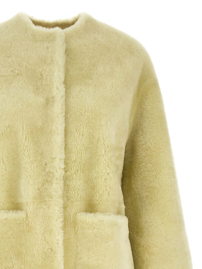 Overcoat by BLANCHA for women in lamb shearling bicolour & green showcases a enveloping silhouette, detailed with distinctive thermal & pockets and a enveloping round neckline.