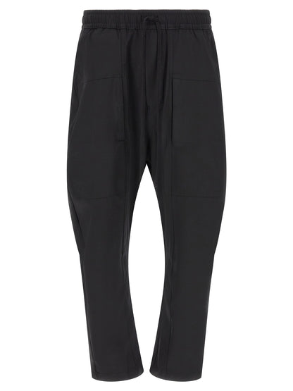 Trousers by Thom Krom for men in polyamide black presents a smart silhouette, meticulously detailed with a smart athletic & relaxed-fit, a smart long, and a smart .