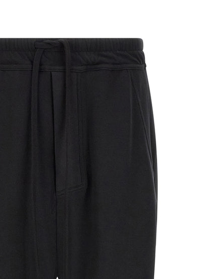 Trousers by Thom Krom for men in organic cotton black features an on trend silhouette, showcasing a sophisticated tapered-leg & relaxed-fit with a long and for an on trend finish.