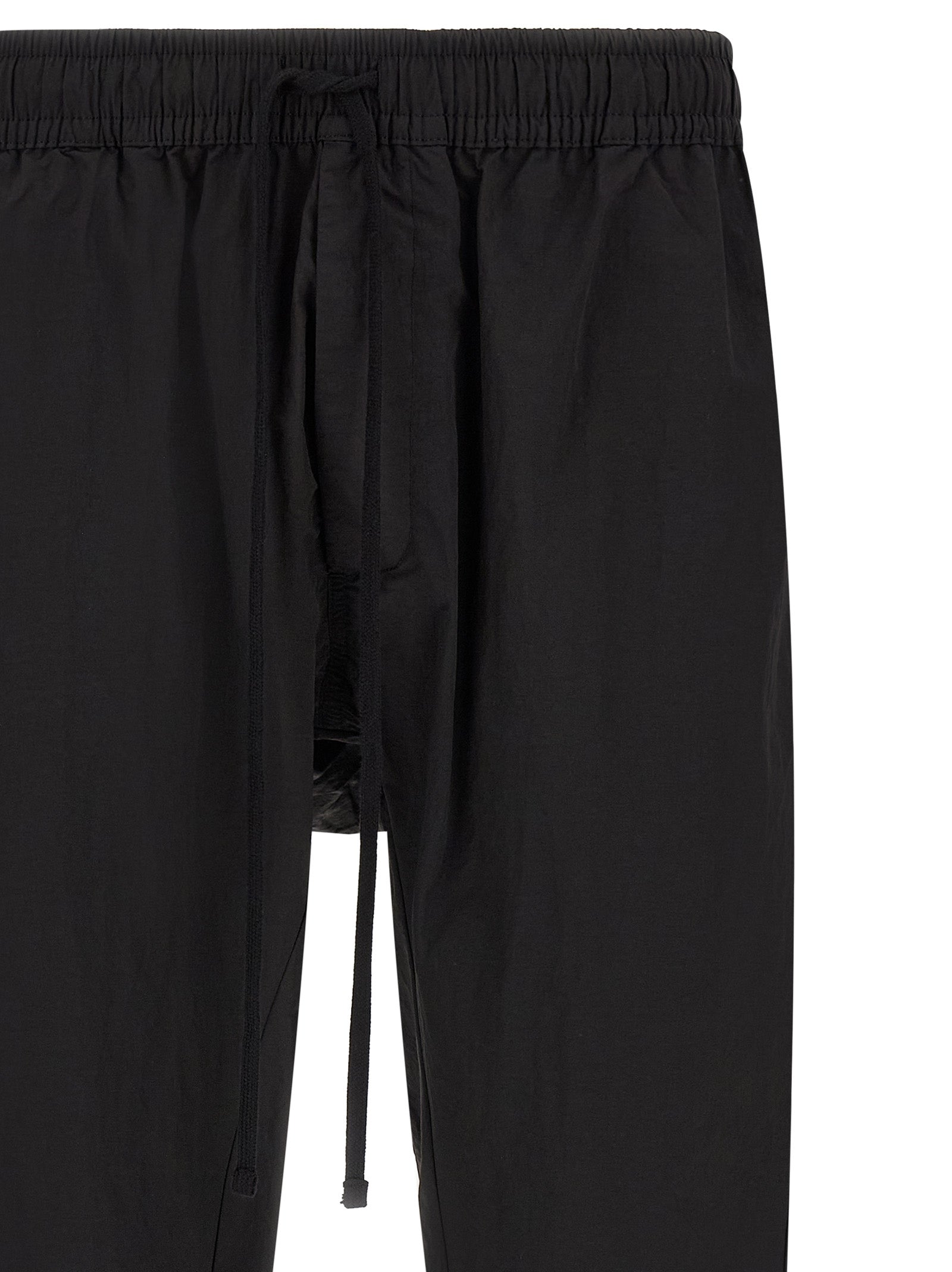 Trousers by Thom Krom for men in horse leather & polyamide black features a tailored silhouette with a tailored relaxed-fit, defined by its long and a sophisticated .