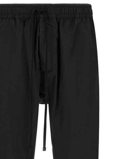 Trousers by Thom Krom for men in horse leather & polyamide black features a tailored silhouette with a tailored relaxed-fit, defined by its long and a sophisticated .