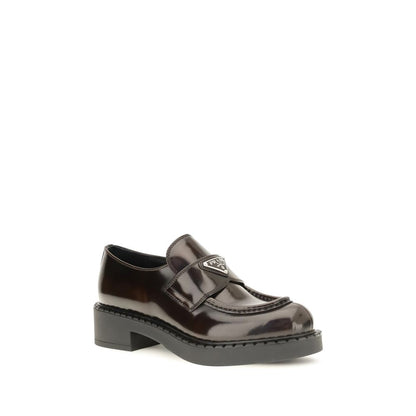 Flat Loafer Slip-On Shoes by Prada for women in bos taurus calf leather brown showcases a resplendent Women's Bos Taurus Calf Leather Flat Loafer Slip-On Shoes aesthetic, defined by its resplendent and elegant flat.