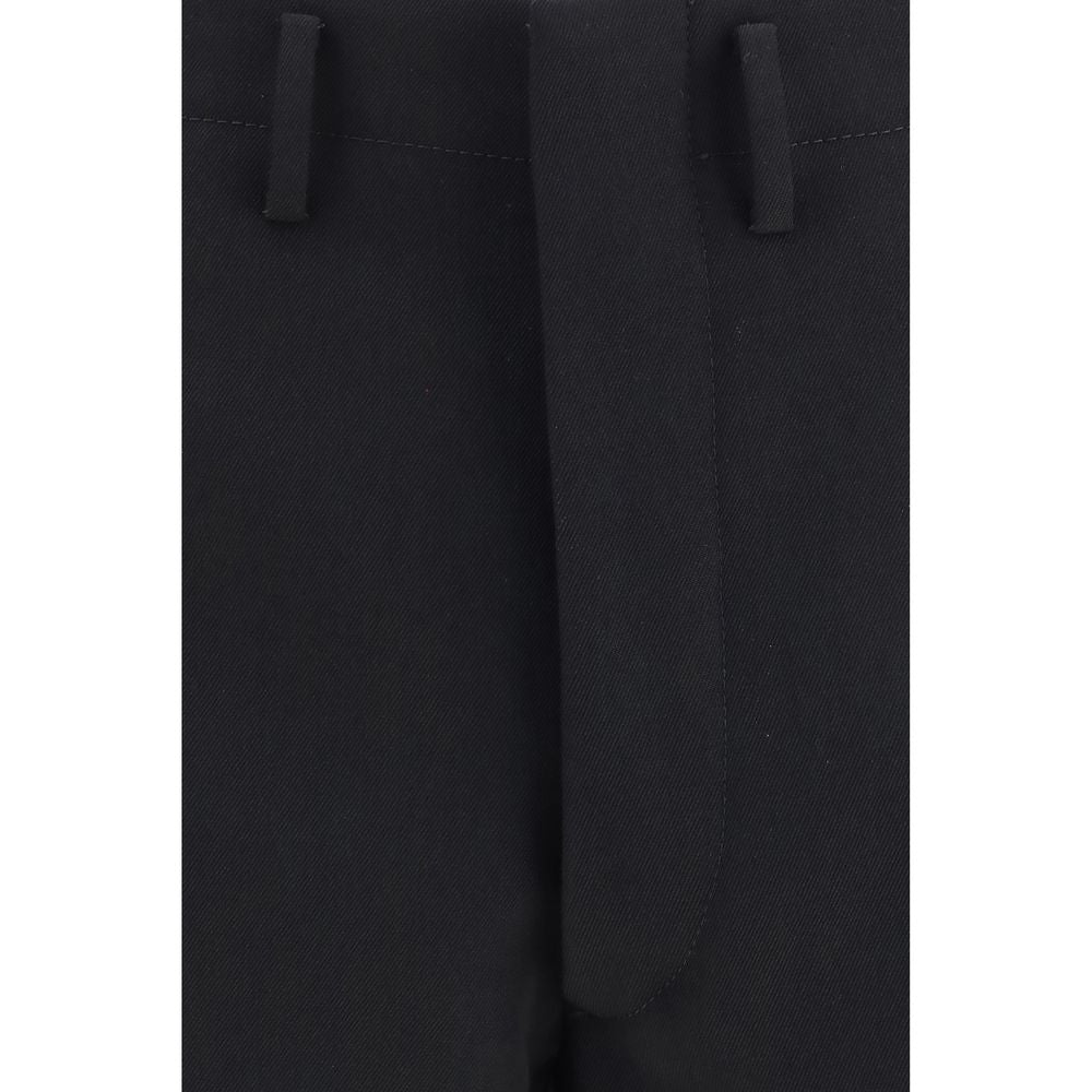 Trousers by Prada for men in wool black presents a smart silhouette, meticulously detailed with a smart regular-fit & wide, a smart long, and a smart high rise.