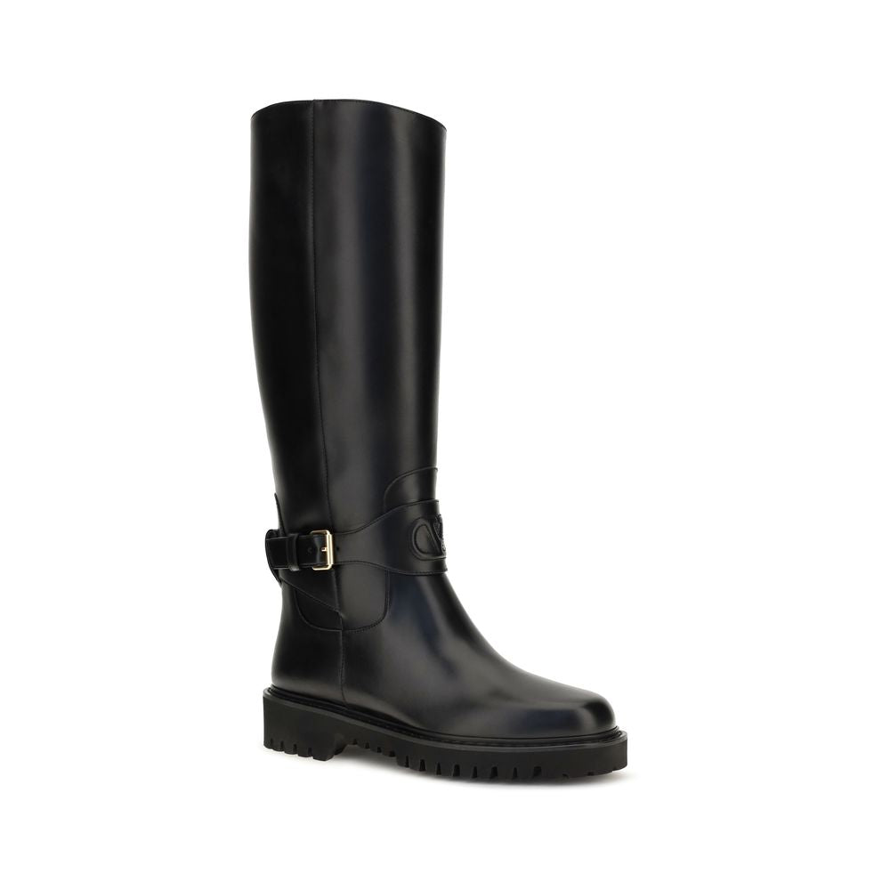Flat Strap Boots by Valentino Garavani for women in bos taurus calfskin leather black & signature features an avant-garde V Logo Women's Bos Taurus Calfskin Leather Flat Strap Boots silhouette, defined by a sophisticated flat and a avant-garde .