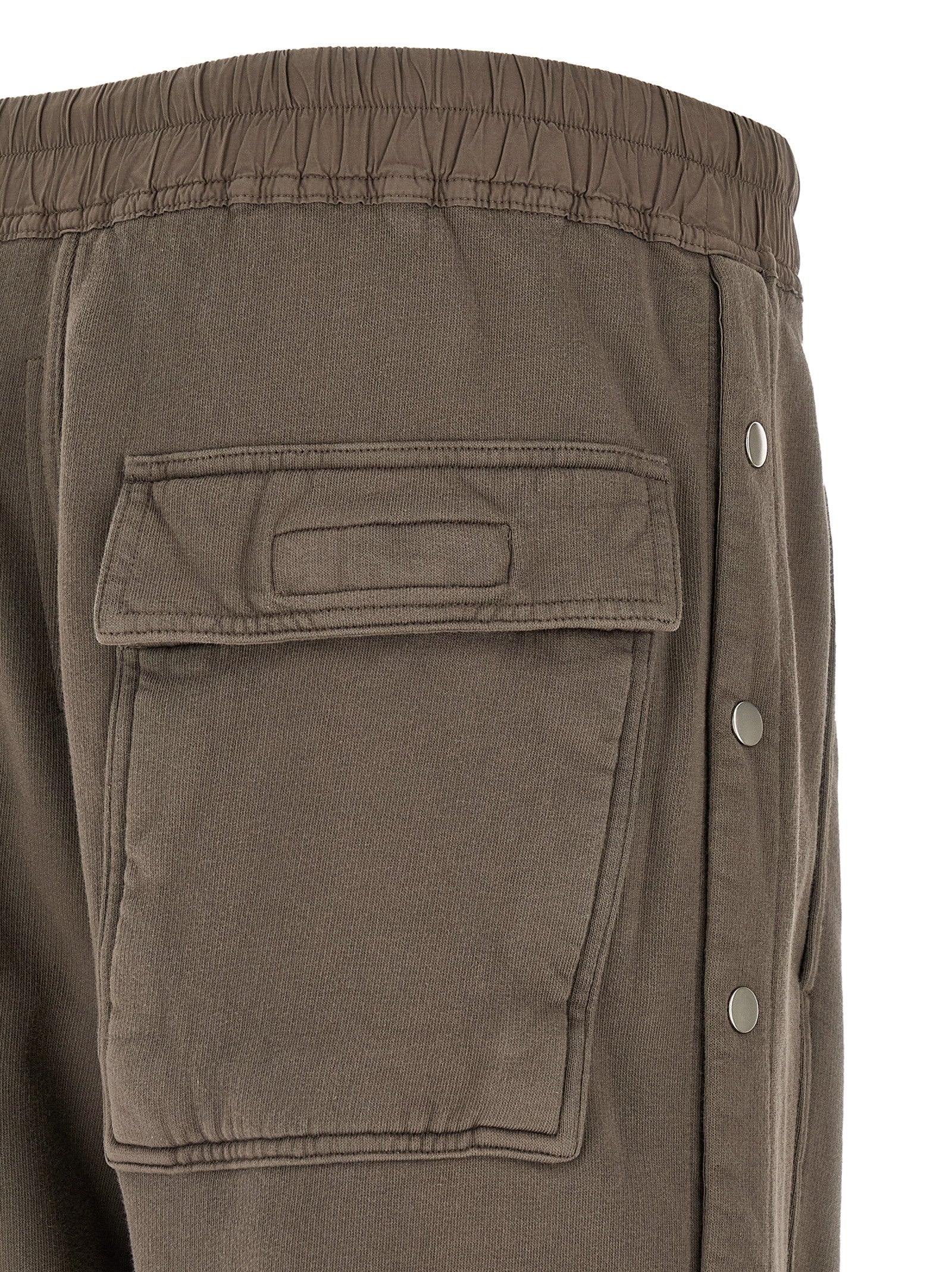 Trousers by DRKSHDW for men in cotton gray presents a perennial silhouette, meticulously tailored with a flared & wide cut, long finish, and an elegant .