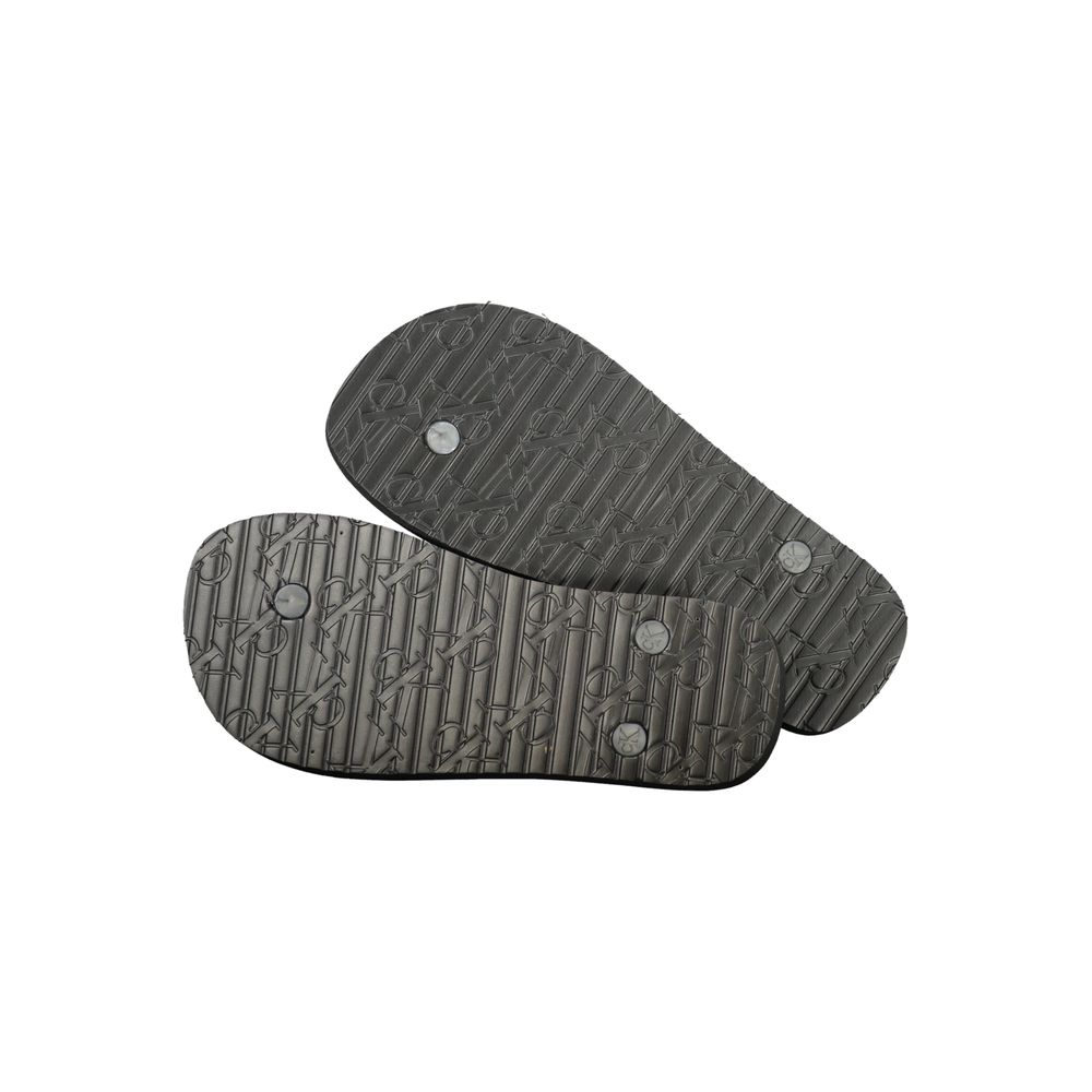 Flip-Flop Sandals by Calvin Klein for women in polyurethane and black & print presents a sculptural silhouette, showcasing the signature style of the Women's Polyurethane Flip-Flop Sandals with a sculptural and sculptural .