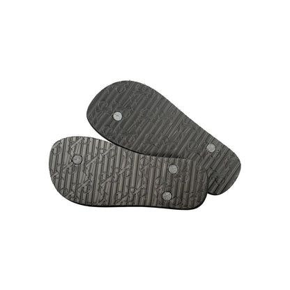 Flip-Flop Sandals by Calvin Klein for women in polyurethane and black & print presents a sculptural silhouette, showcasing the signature style of the Women's Polyurethane Flip-Flop Sandals with a sculptural and sculptural .
