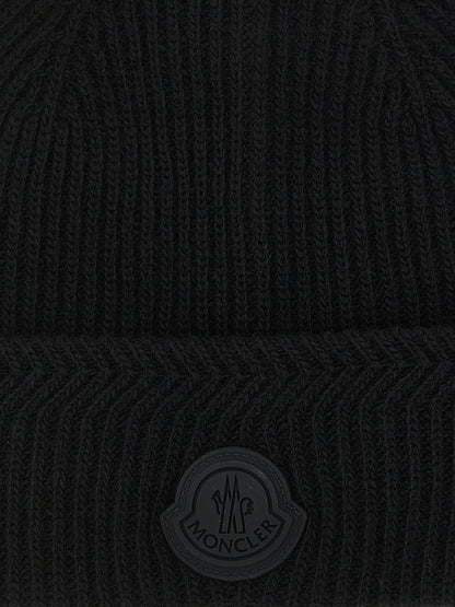 Beanie Hat by Moncler for men in cashmere virgin wool black, patterned & herringbone presents a sleek silhouette, showcasing the sleek texture and refined craftsmanship of the Cashmere Virgin Wool Beanie Hat collection.