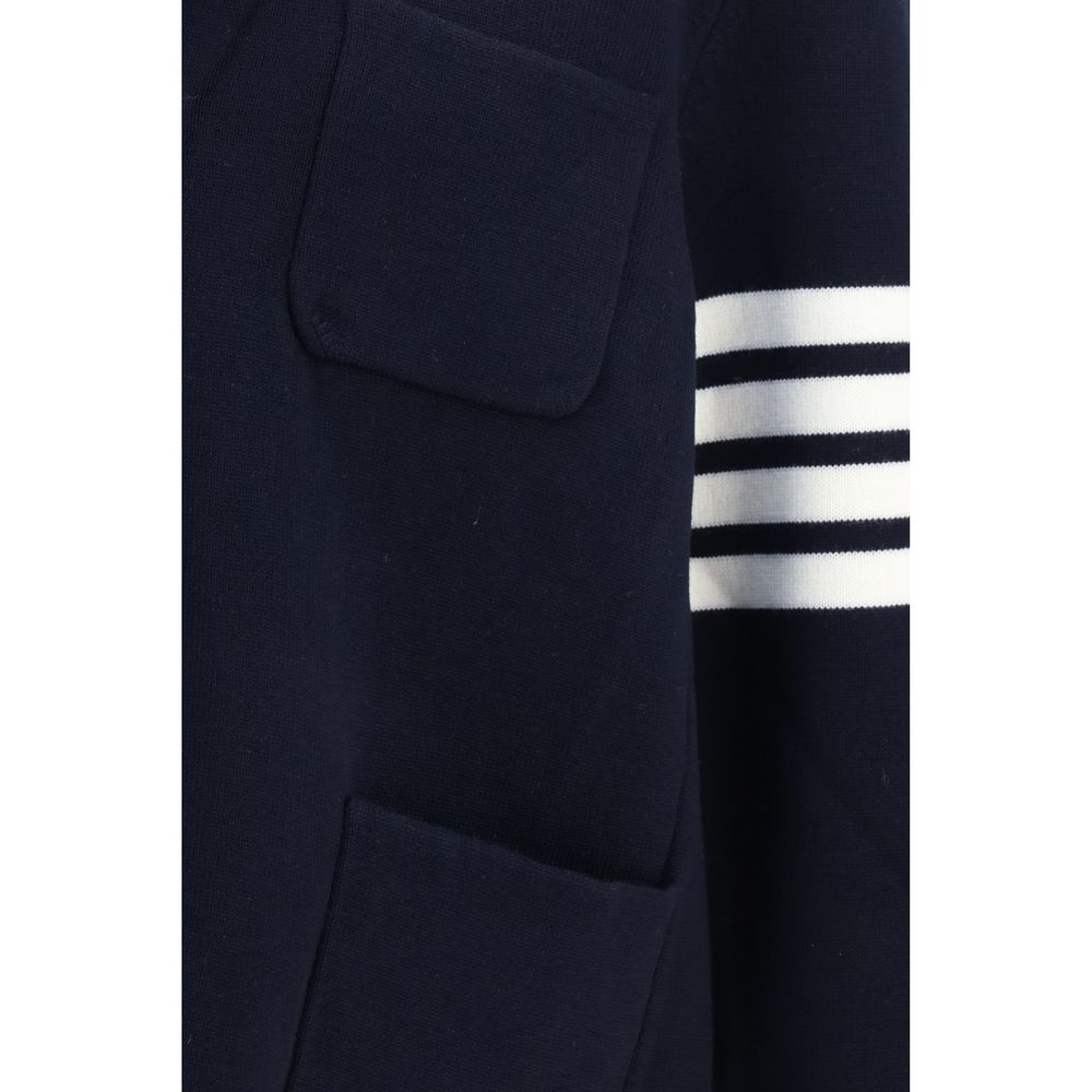 Overcoat by Thom Browne for men in polyamide & wool blue, signature & striped showcases a architectural silhouette, artfully detailed with a distinctive and functional pockets for a architectural finish.