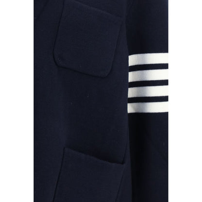 Overcoat by Thom Browne for men in polyamide & wool blue, signature & striped showcases a architectural silhouette, artfully detailed with a distinctive and functional pockets for a architectural finish.
