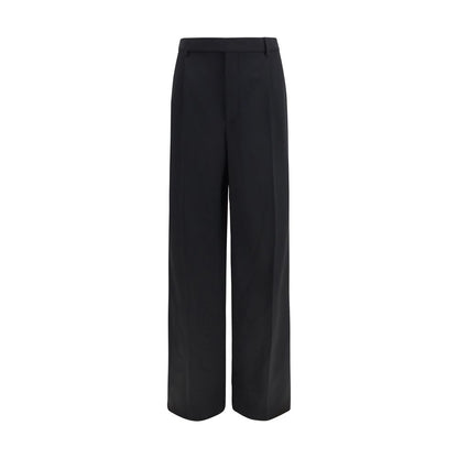 Trousers by Saint Laurent for men in wool black features a sculptural silhouette, showcasing a sculptural straight-leg & regular-fit and long with a sophisticated mid rise for a sculptural finish.