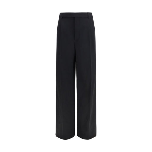 Trousers by Saint Laurent for men in wool black features a sculptural silhouette, showcasing a sculptural straight-leg & regular-fit and long with a sophisticated mid rise for a sculptural finish.