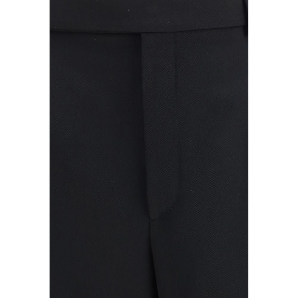 Trousers by Saint Laurent for men in wool black features a artisanal silhouette, showcasing a sophisticated straight-leg & regular-fit with a long and mid rise for a artisanal finish.