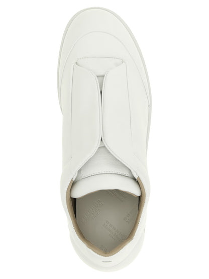 Sneakers by Maison Margiela for men in calfskin leather white & signature presents a sumptuous silhouette, artfully capturing the essence of the Men's Low Top Calfskin Leather Sneakers with its sumptuous low-top style design.