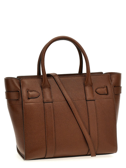 This Small Tote Bag by Mulberry for women in leather & metal brown features an on trend Leather & Metal Small Tote Bag design with a secure zipper, ample , and on trend shoulder-strap & handle.