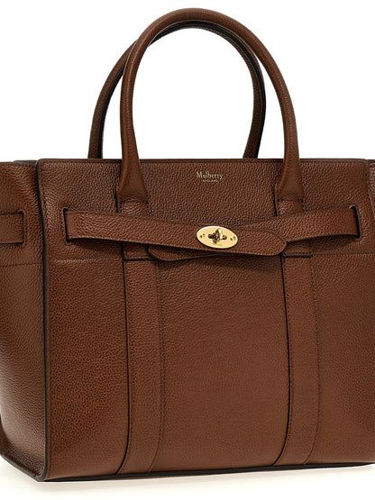 This Small Tote Bag by Mulberry for women in leather & metal brown features an on trend Leather & Metal Small Tote Bag design with a secure zipper, ample , and on trend shoulder-strap & handle.