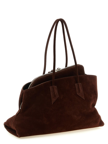 Medium Shoulder Bag by The Attico for women in bos taurus suede leather brown & silver presents a versatile silhouette, showcasing a secure zipper and versatile with versatile shoulder-strap & handle for a sophisticated look.