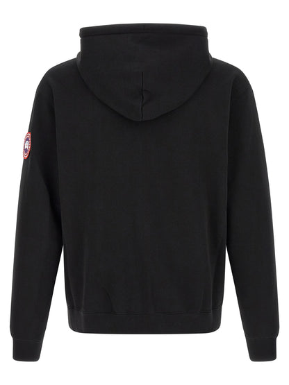 Sweatshirt Hoodie by Canada Goose for men in cotton terrycloth black & silver features an luminous silhouette, showcasing a sophisticated hooded split neckline and for a truly luminous look.