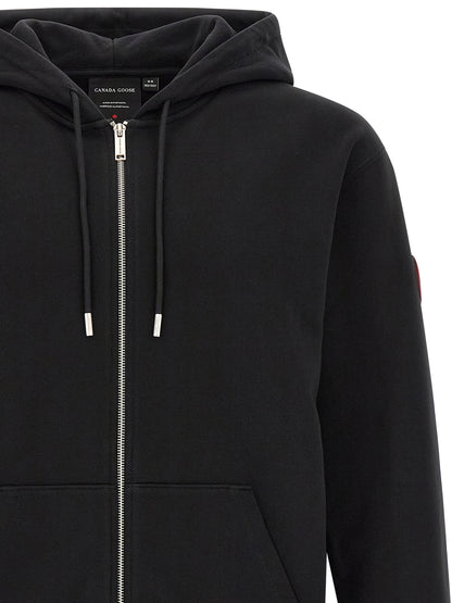 Sweatshirt Hoodie by Canada Goose for men in cotton terrycloth black & silver showcases a city-ready silhouette, artfully detailed with a signature hooded split neckline and for a city-ready finish.