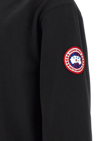 Sweatshirt Hoodie by Canada Goose for men in cotton terrycloth black features a slouchy chic silhouette, detailed with a slouchy chic and a signature for an elevated aesthetic.
