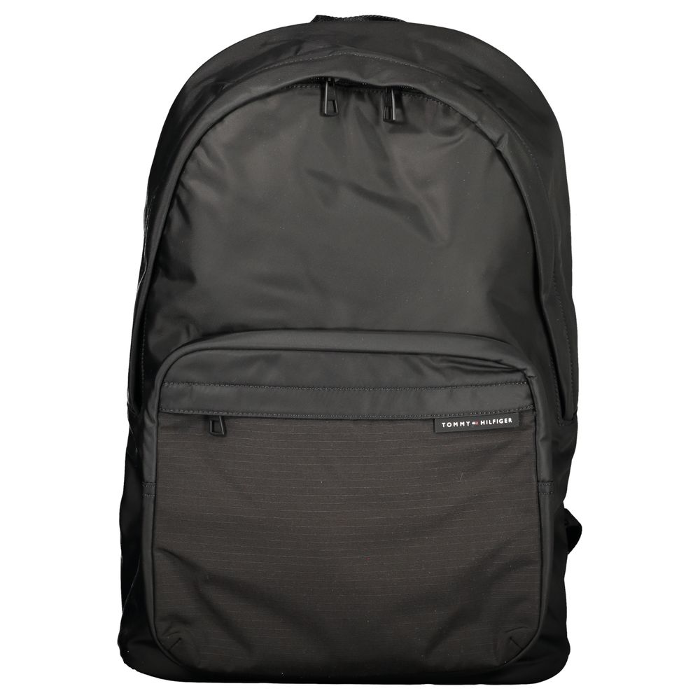 Backpack by Tommy Hilfiger for men in polyester black presents a stately Polyester Backpack design, showcasing a secure zipper with ample external-pockets, internal-pockets & laptop-compartment and versatile backpack-strap, adjustable-strap & handle for a stately finish.