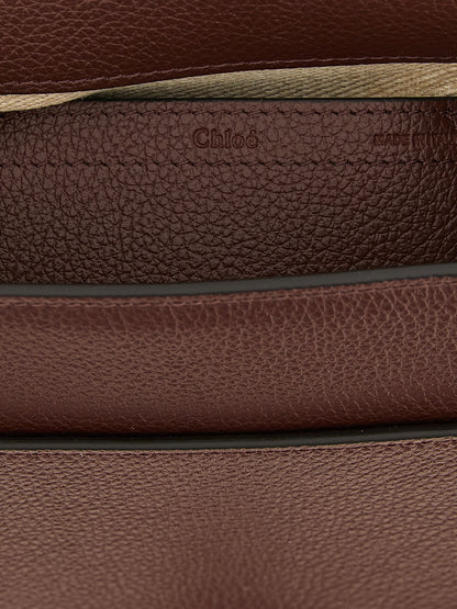 Crossbody Saddle Handbag by Chloé for women in linen & bos taurus calfskin leather brown & gold features a transformative sophistication silhouette, showcasing a secure , ample , and versatile crossbody-strap, shoulder-strap & adjustable-strap for a transformative sophistication look.