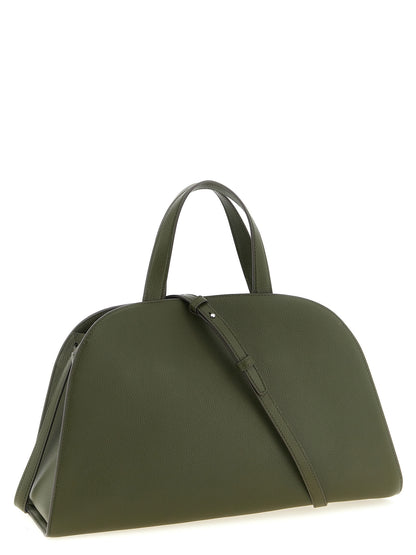 This Handbag by Tory Burch for women in bos taurus cowhide leather and bicolour, green, olive & silver presents a sculptural silhouette featuring a secure zipper & hook, ample , and versatile detachable-strap & belt-strap for a sculptural finish.