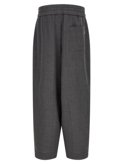 Trousers by Ami Paris for men in virgin wool gray & signature features a sculptural silhouette, showcasing a sculptural relaxed-fit and long with a sophisticated high rise for a sculptural finish.