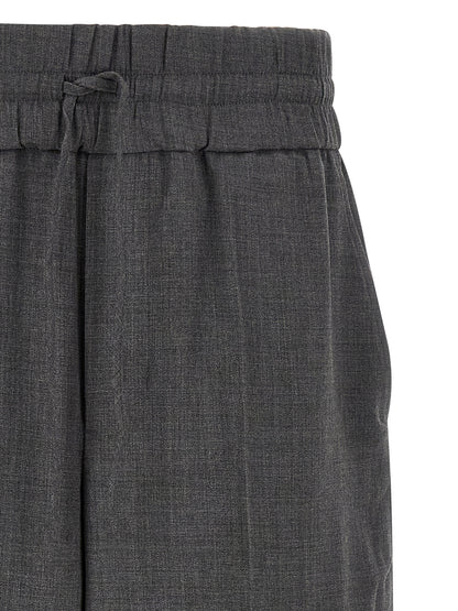 Trousers by Ami Paris for men in virgin wool gray & signature features a tailored silhouette with a tailored relaxed-fit, defined by its long and a sophisticated high rise.